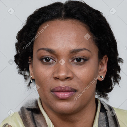 Joyful black adult female with short  brown hair and brown eyes