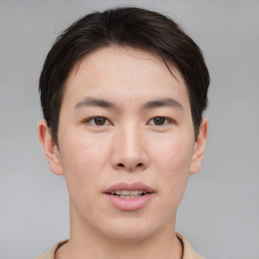 Joyful asian young-adult male with short  brown hair and brown eyes