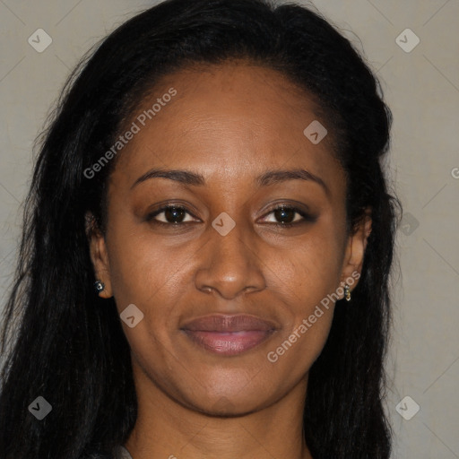 Joyful black young-adult female with long  brown hair and brown eyes