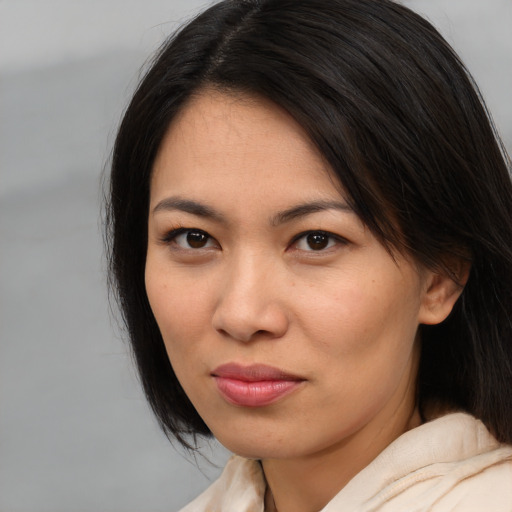 Joyful asian young-adult female with medium  brown hair and brown eyes