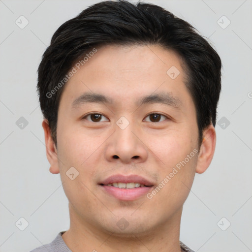 Joyful asian young-adult male with short  brown hair and brown eyes