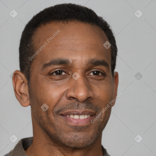 Joyful black adult male with short  brown hair and brown eyes