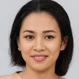 Joyful asian young-adult female with medium  brown hair and brown eyes