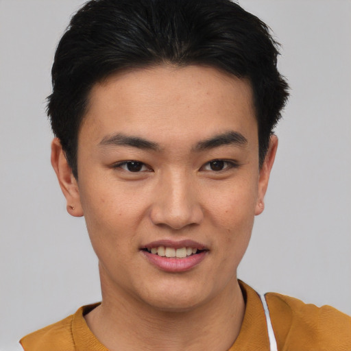 Joyful asian young-adult male with short  black hair and brown eyes