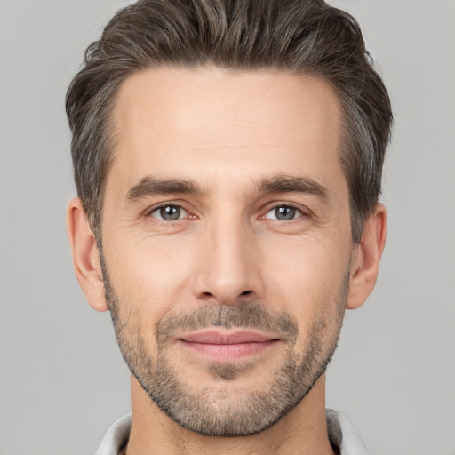 Joyful white adult male with short  brown hair and brown eyes