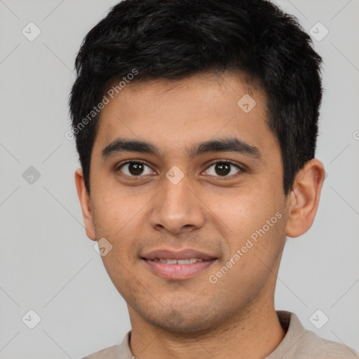 Joyful latino young-adult male with short  black hair and brown eyes