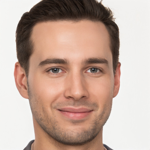 Joyful white young-adult male with short  brown hair and brown eyes