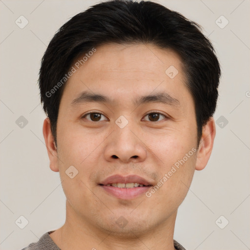 Joyful asian young-adult male with short  brown hair and brown eyes