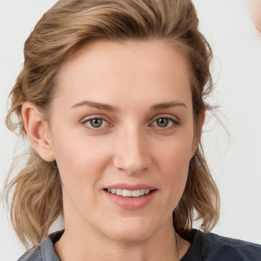 Joyful white young-adult female with medium  brown hair and blue eyes