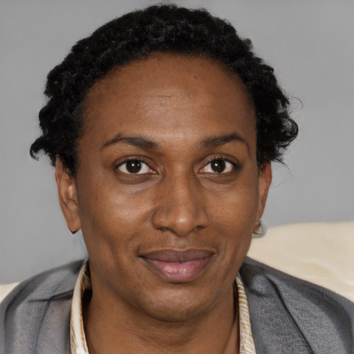 Joyful black adult female with short  brown hair and brown eyes