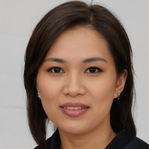 Joyful white young-adult female with medium  brown hair and brown eyes