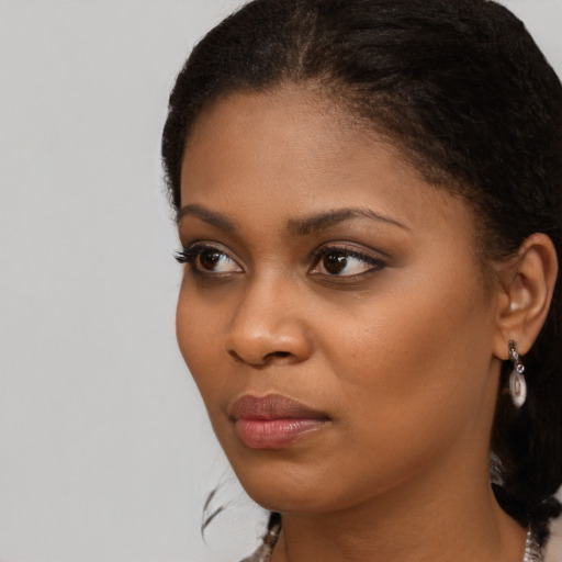 Neutral black young-adult female with long  brown hair and brown eyes