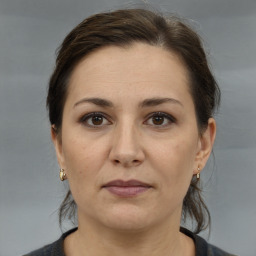 Joyful white adult female with medium  brown hair and brown eyes