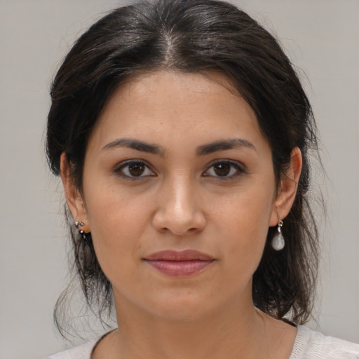 Joyful latino young-adult female with medium  brown hair and brown eyes
