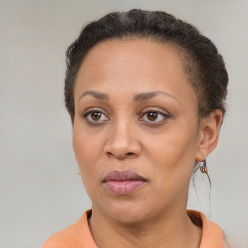 Joyful black adult female with short  brown hair and brown eyes