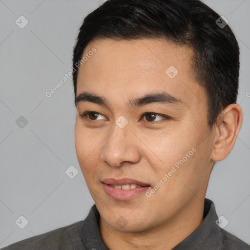 Joyful latino young-adult male with short  brown hair and brown eyes