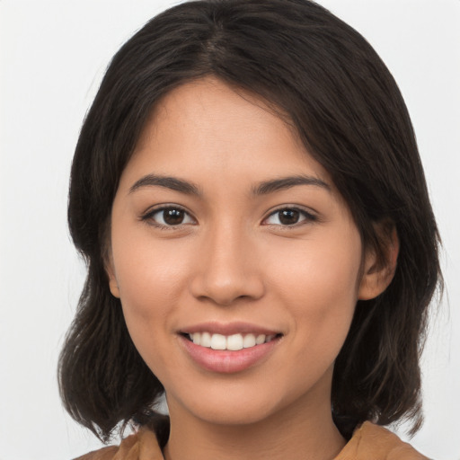 Joyful asian young-adult female with medium  brown hair and brown eyes