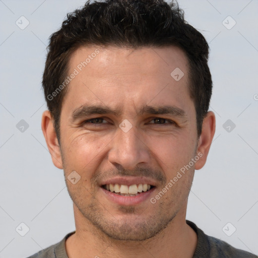 Joyful white adult male with short  brown hair and brown eyes