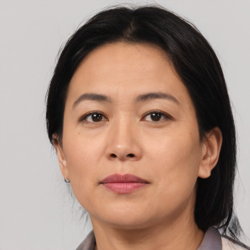 Joyful asian adult female with medium  brown hair and brown eyes