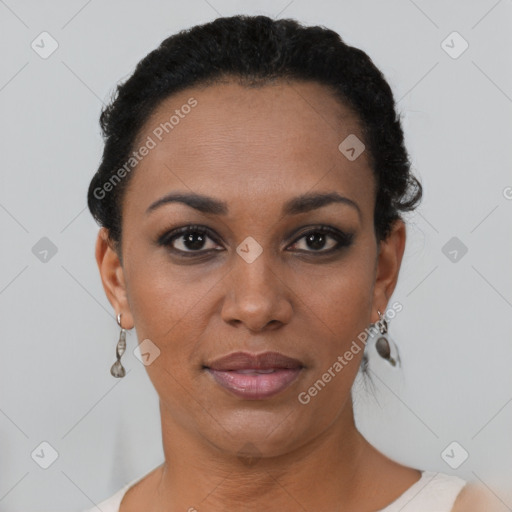 Joyful black young-adult female with short  black hair and brown eyes