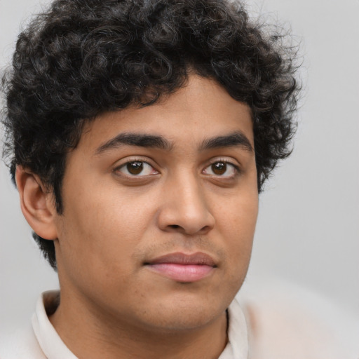 Joyful latino young-adult male with short  brown hair and brown eyes