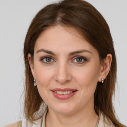 Joyful white young-adult female with medium  brown hair and grey eyes