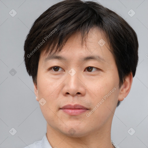 Joyful asian adult male with short  brown hair and brown eyes