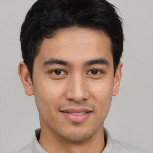 Joyful asian young-adult male with short  brown hair and brown eyes