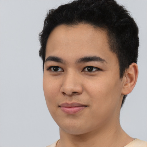 Joyful asian young-adult male with short  black hair and brown eyes