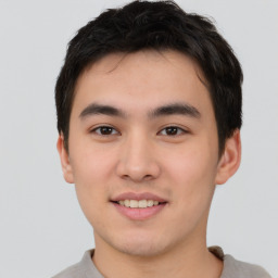 Joyful asian young-adult male with short  brown hair and brown eyes