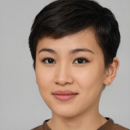 Joyful asian young-adult female with short  black hair and brown eyes