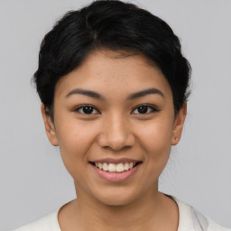 Joyful latino young-adult female with short  black hair and brown eyes