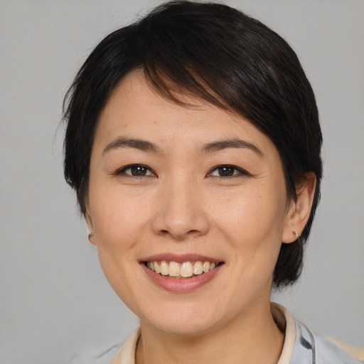 Joyful white young-adult female with medium  brown hair and brown eyes