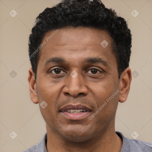 Joyful latino adult male with short  black hair and brown eyes