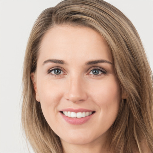 Joyful white young-adult female with long  brown hair and brown eyes