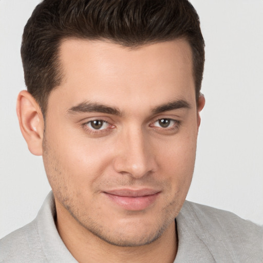 Joyful white young-adult male with short  brown hair and brown eyes