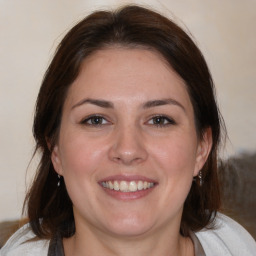 Joyful white adult female with medium  brown hair and brown eyes