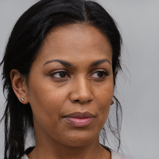 Joyful black adult female with medium  brown hair and brown eyes