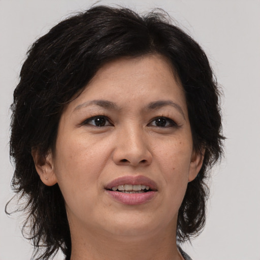 Joyful white adult female with medium  brown hair and brown eyes