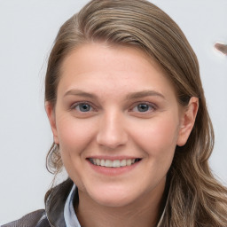 Joyful white young-adult female with long  brown hair and blue eyes