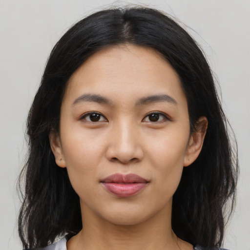 Joyful latino young-adult female with long  black hair and brown eyes