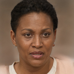 Joyful black adult female with short  brown hair and brown eyes