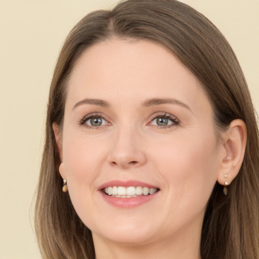 Joyful white young-adult female with long  brown hair and brown eyes