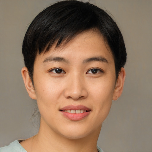 Joyful asian young-adult female with short  brown hair and brown eyes