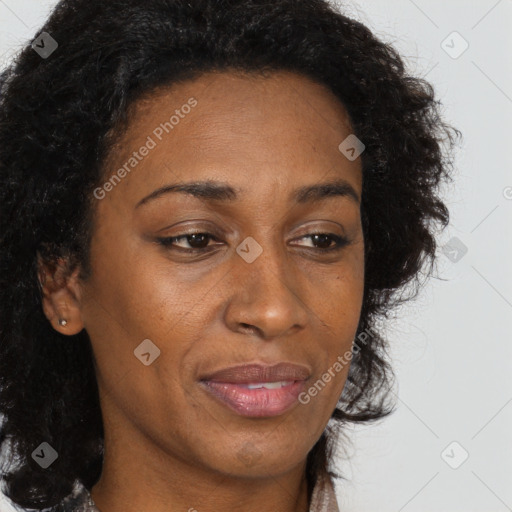 Joyful black adult female with long  brown hair and brown eyes