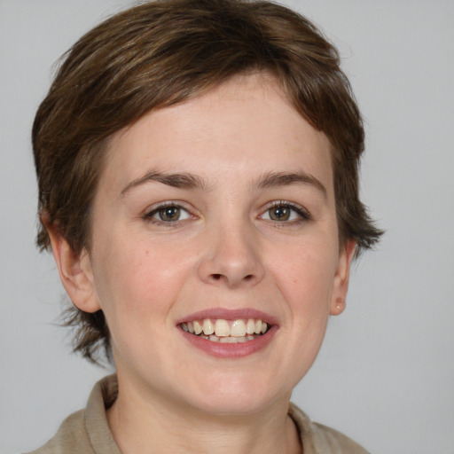 Joyful white young-adult female with medium  brown hair and grey eyes