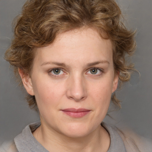 Joyful white young-adult female with medium  brown hair and blue eyes