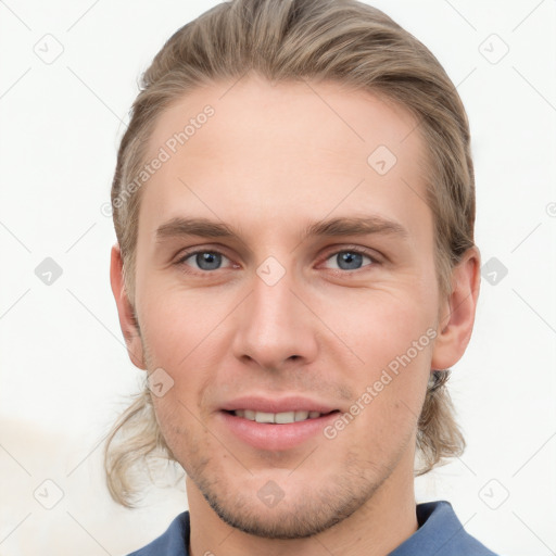 Joyful white young-adult male with short  brown hair and grey eyes