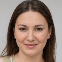 Joyful white young-adult female with medium  brown hair and brown eyes