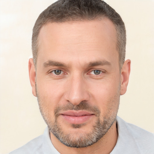 Joyful white adult male with short  brown hair and brown eyes